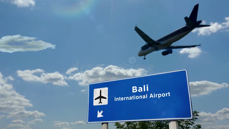Plaque d'atterrir à l'aéroport de Bali, Indonésie auprès de l'enseigne. Atterrissage de silhouette d'avion à Bali (Indonésie). Arrivée de ville avec l'enseigne de direction de l'aéroport international et le ciel bleu à l'arrière-plan. Voyage de voyage et illustration du concept de transport 3d