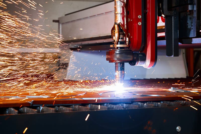 Plasma Cutting of Metal Plate with Flying Sparks in Workshop Stock