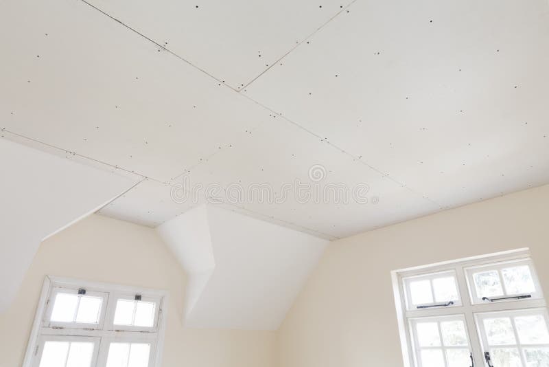 Plasterboard ceiling in a house interior renovation. New gypsum plasterboard ceiling in room of an old house interior renovation, UK royalty free stock photo Plasterboard ceiling in a house interior renovation. New gypsum plasterboard ceiling in room of an old house interior renovation, UK royalty free stock photo