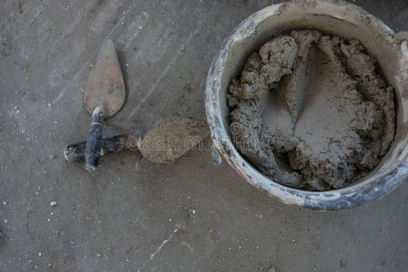plastering-trowel-mixed-cement-bucket-plastering-trowel-mixed-cement-bucket-floor-construction-site-186167573.jpg
