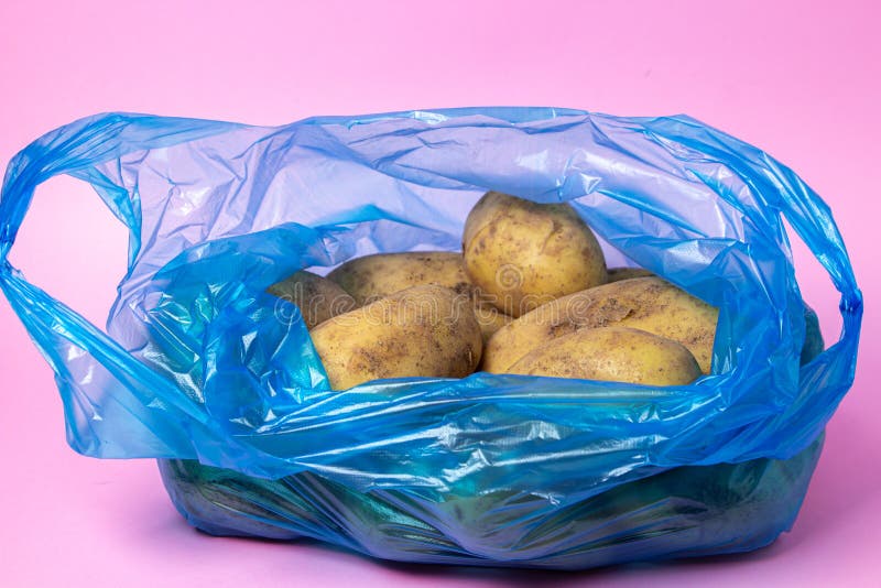 Plastic Bag with Potatoes on a Pink Background. Stock Photo Image of