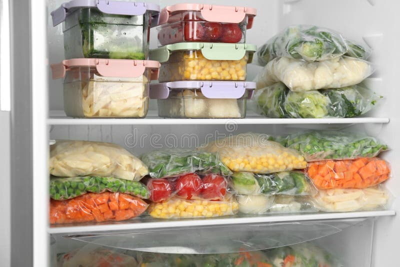 Plastic Bags and Containers with Frozen Vegetables in Refrigerator