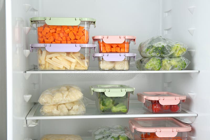 Plastic Bags and Containers with Frozen Vegetables in Refrigerator