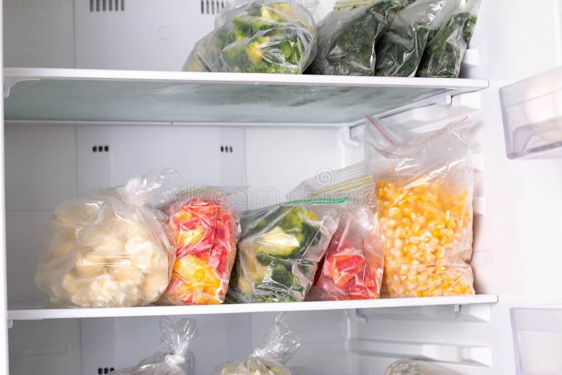 Plastic Bags with Deep Frozen Vegetables in Refrigerator, Closeup Stock