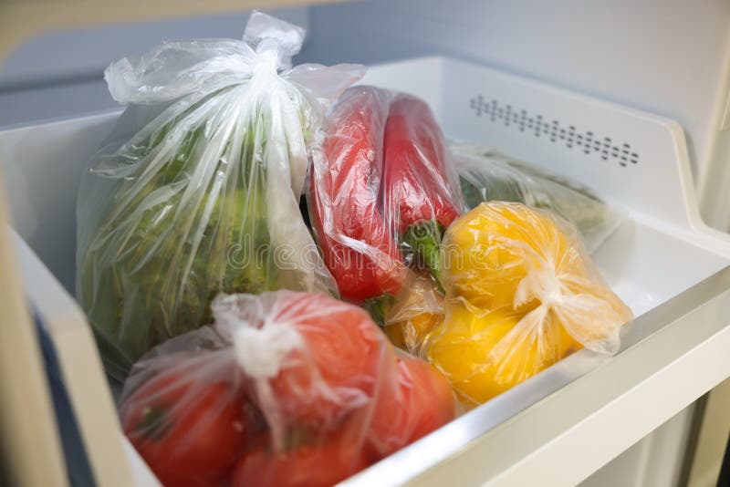 Plastic Bags with Different Fresh Products in Refrigerator, Closeup
