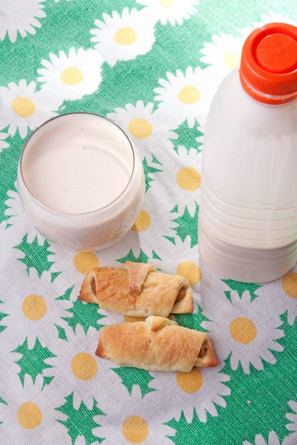 Plastic bottle with clabber, glass and bagels