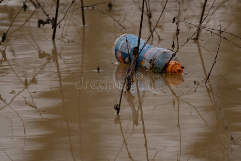 Plastic Bottle Floating in the River Welland Which is Brown with Mud