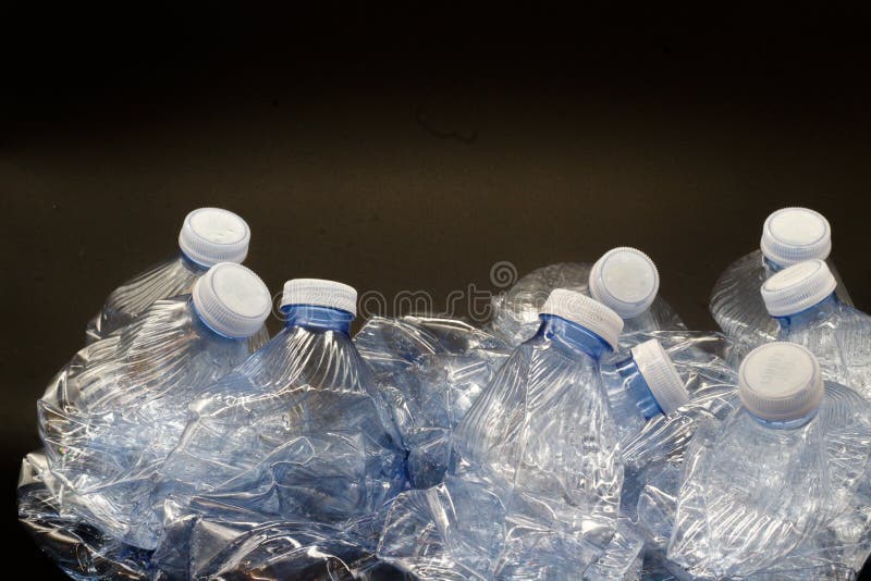 Plastic Bottles Inside Yellow Bag for Recycling on Black Background