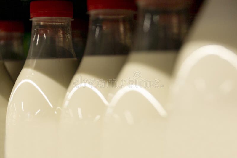 Plastic Bottles with Milk in the Store. Closeup Stock Photo Image of
