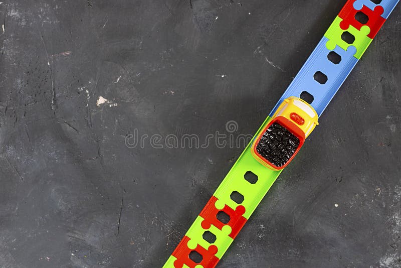 Plastic bright toy truck on curved road on black chalkboard background with copy space. Top view. Creative concept for transport royalty free stock image Plastic bright toy truck on curved road on black chalkboard background with copy space. Top view. Creative concept for transport royalty free stock image
