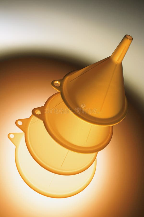 Stack of Plastic Kitchen Funnels with Warm Glow. Stack of Plastic Kitchen Funnels with Warm Glow