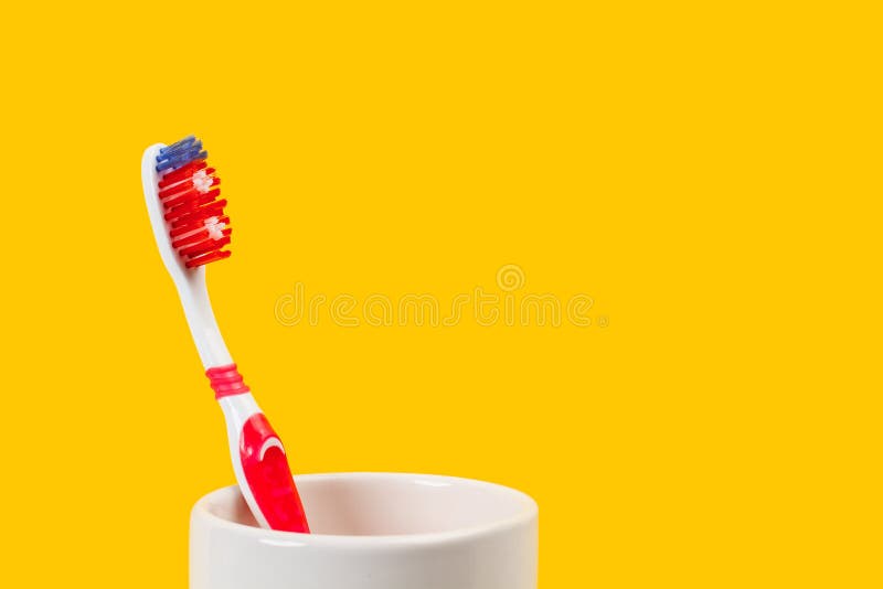 Plastic Colored Toothbrush in a Ceramic Glass Stock Image Image of