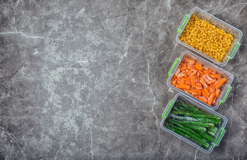 Plastic Containers with Frozen Vegetables on Table Stock Photo Image