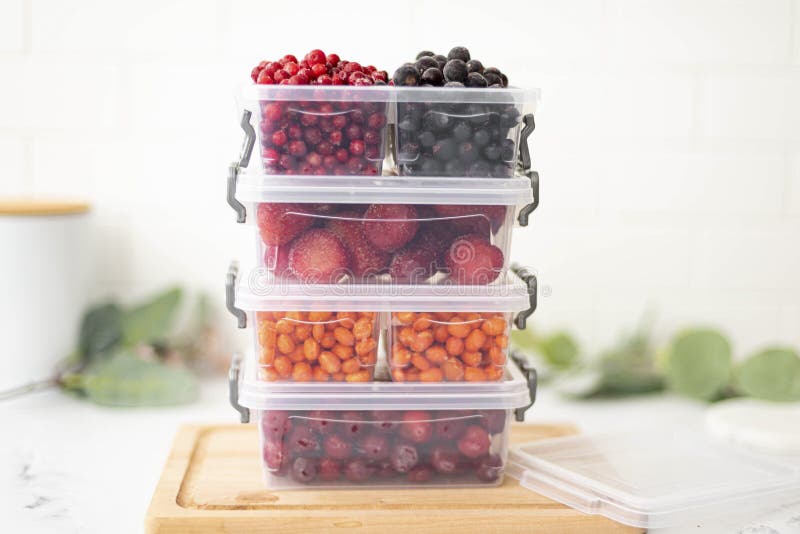Plastic Containers with Mix of Frozen Berries on the Kitchen Table, Closeup Stock Image Image