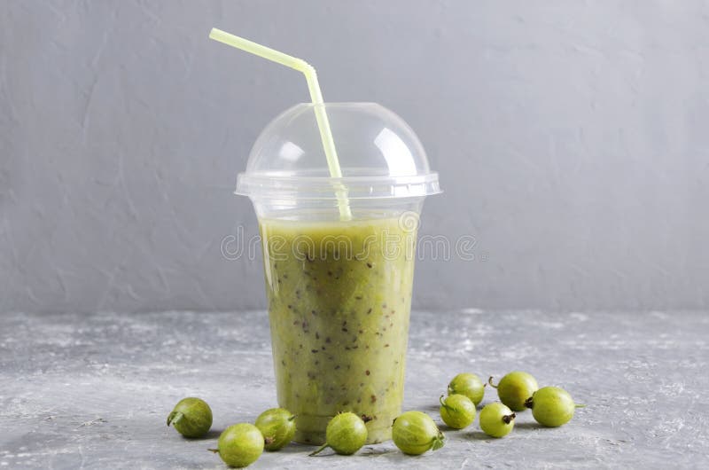Plastic cup of refreshing smoothie.Gooseberry blended beverage royalty free stock photography Plastic cup of refreshing smoothie.Gooseberry blended beverage royalty free stock photography