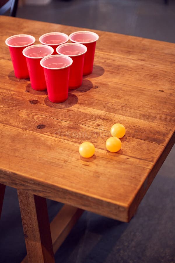 Plastic Cups and Balls on Wooden Table Ready for Party Game at Home