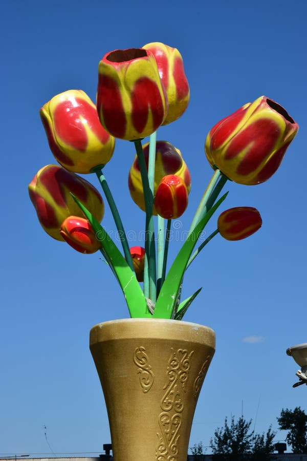 Red Tulips In Plastic Packaging On White Wooden Background, Beautiful Spring Flowers Stock Image