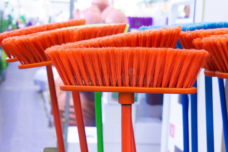 Plastic Home Cleaning Brushes DIY Store. Assortment of Multicolored Floor Brooms Stock Photo