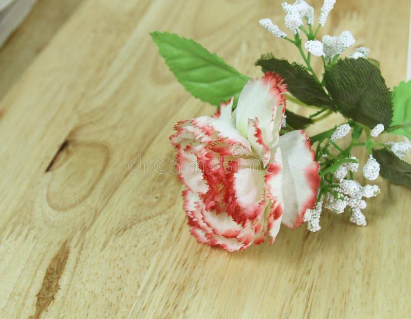 Plastic Flowers and Plastic Leaf Put on the Table Wood. Stock Photo