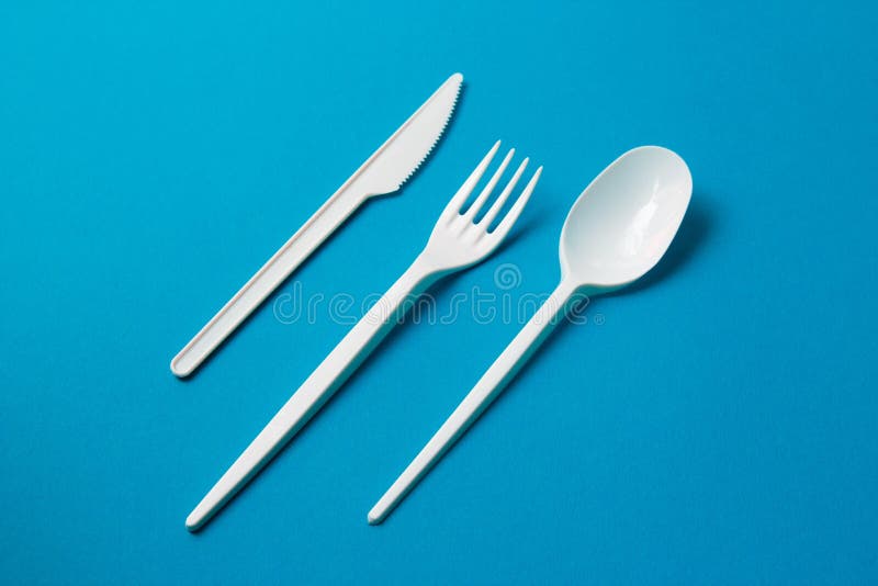 Plastic Fork, Spoon and Knive on Blue Background