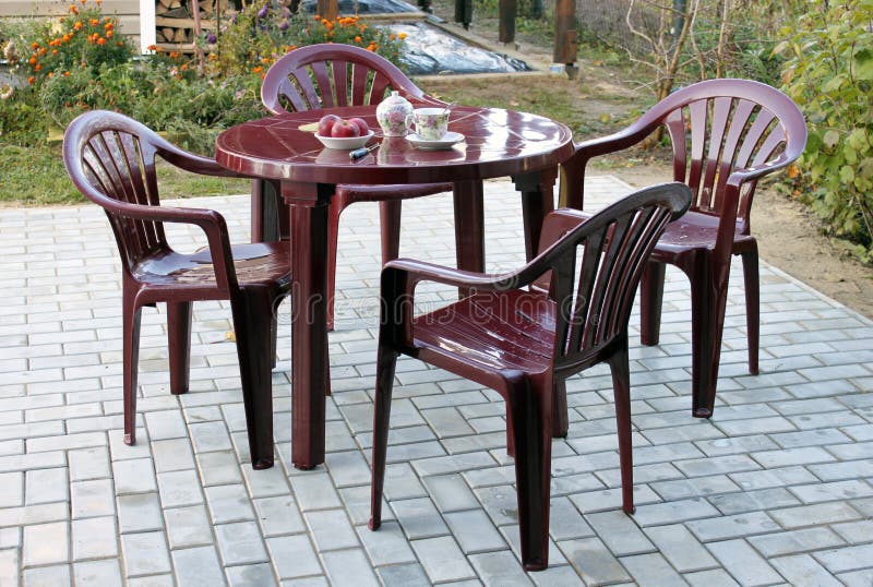 Plastic furniture. In the autumn on a patio near a country house royalty free stock photography