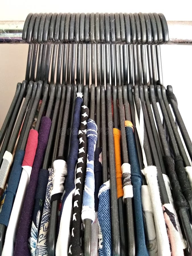 Plastic Hangers with Clothes Elegantly Arranged Inside the Closet Stock