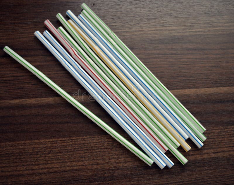Plastic Multi Coloured Drinking Straws on a Flat Surface. Stock Photo