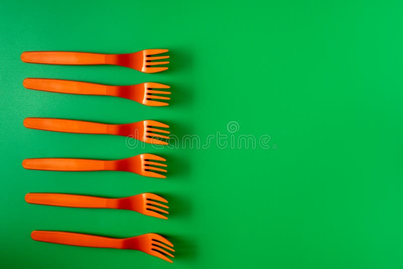 Plastic Orange Forks Flat Lay on Green Background Stock Image Image