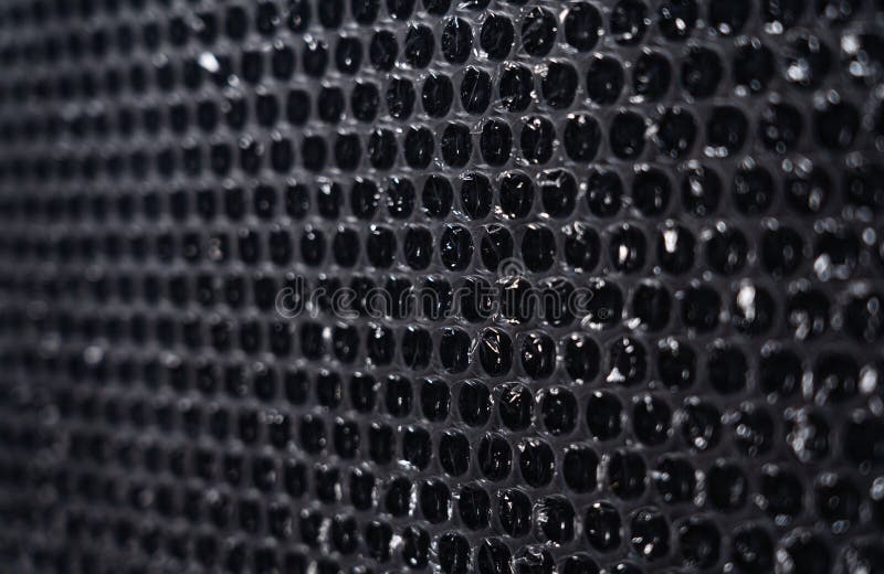 Plastic Packaging Material with Air Bubbles on Black Background Stock