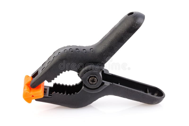Plastic spring clamp isolated on white background. Clamping equipment. Working hand tool. Black and orange spring clamp. Close-up stock photos