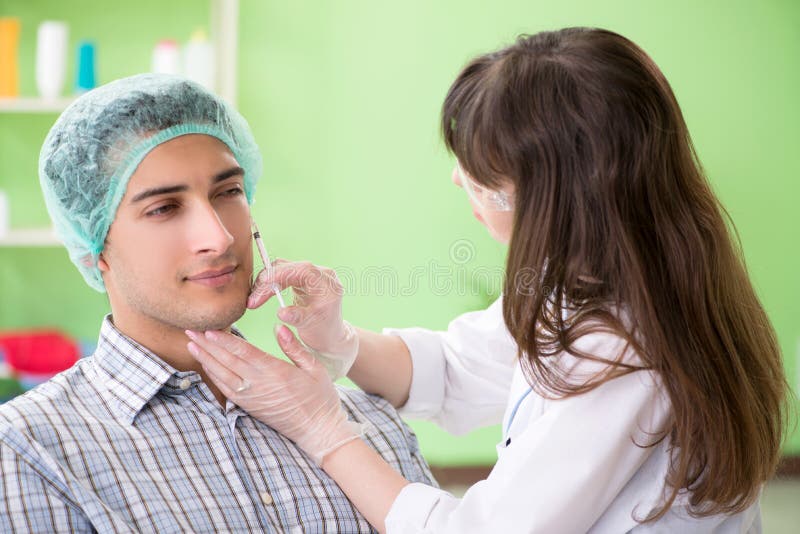 The Plastic Surgeon Preparing for Operation on Man Face Stock Image