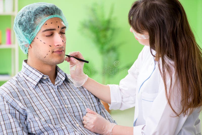 The Plastic Surgeon Preparing for Operation on Man Face Stock Image