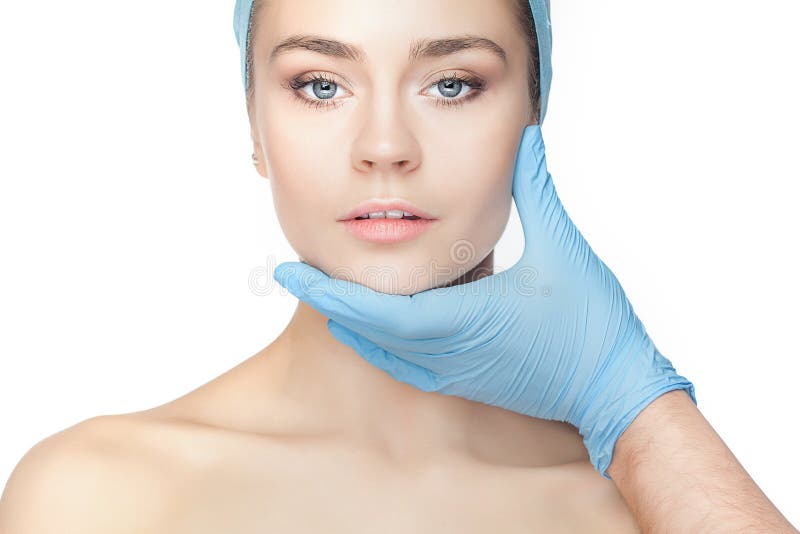 Plastic surgery concept. Doctor hands in gloves touching woman face stock images Plastic surgery concept. Doctor hands in gloves touching woman face stock images