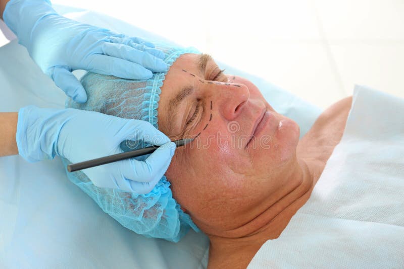 Plastic surgery concept. Hands marking face royalty free stock photos Plastic surgery concept. Hands marking face royalty free stock photos
