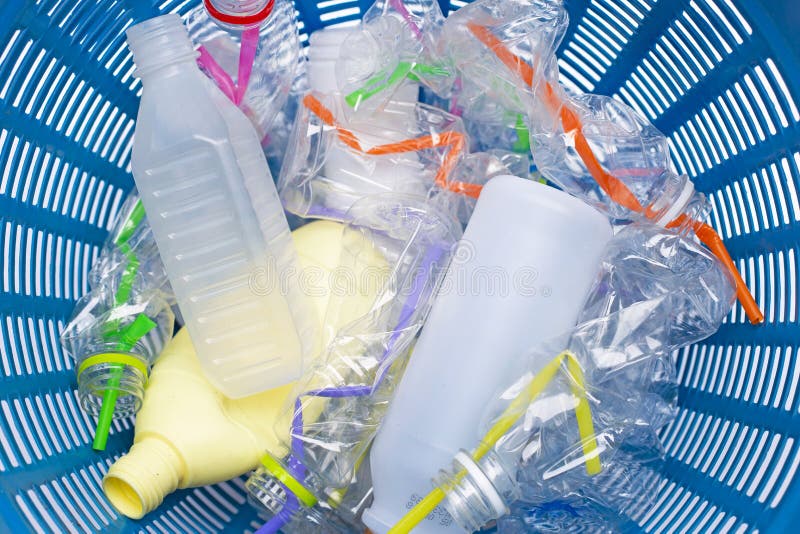 Plastic Waste, Plastic Bottles with Straws in Waste Basket Stock Photo
