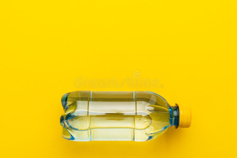 Plastic Water Bottle with Yellow Cap on Yellow Background with Copy