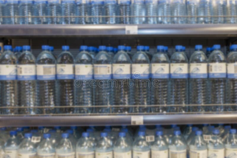 Plastic Water Bottles on Store Shelves. Blurred Stock Photo Image of