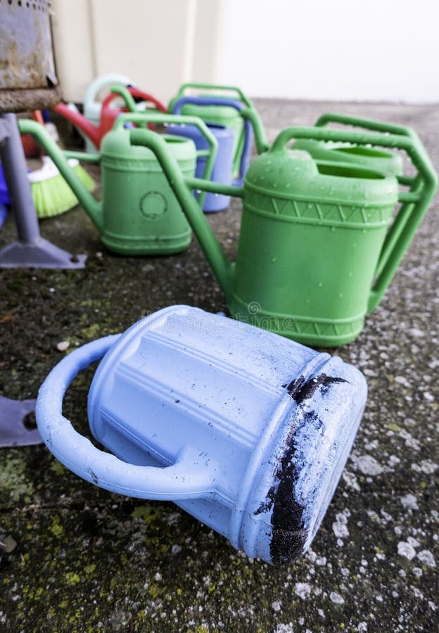 Plastic watering cans stock image. Image of garden, growth 238161061