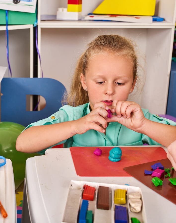 Plasticine modeling clay. Child dough play in school.