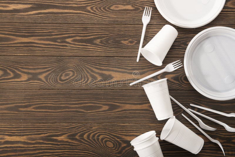Plastikowy tableware na drewnianym tle Drugorzędny przerób Poj?cie zero odpad?w zdjęcia royalty free Plastikowy tableware na drewnianym tle Drugorzędny przerób Poj?cie zero odpad?w zdjęcia royalty free