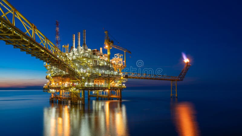 Plataforma central de transformación de petróleo y gas mar adentro en puesta de sol que produce gas crudo, crudo e hidrocarburos