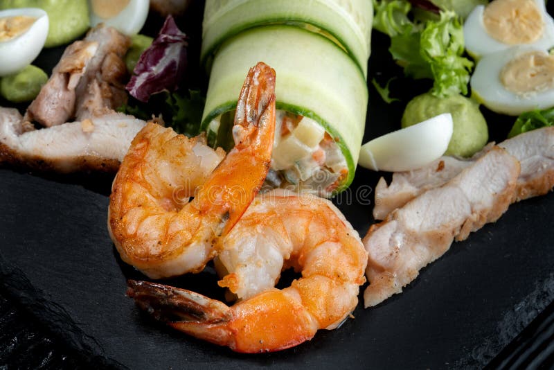 Plate with Appetizers, Shrimp, Cucumber, Eggs, Salad. Stock Image