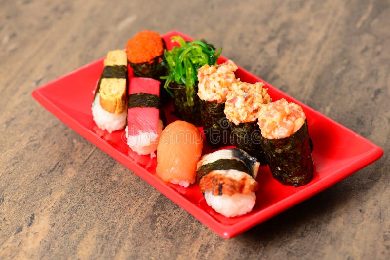 Plate with assorted sushi stock photo. Image of meal 142864352