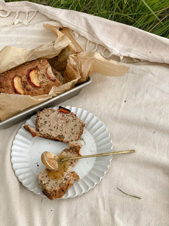 Plate of Bread Loaf and a Spoon Full of Peanut Butter on the Beige