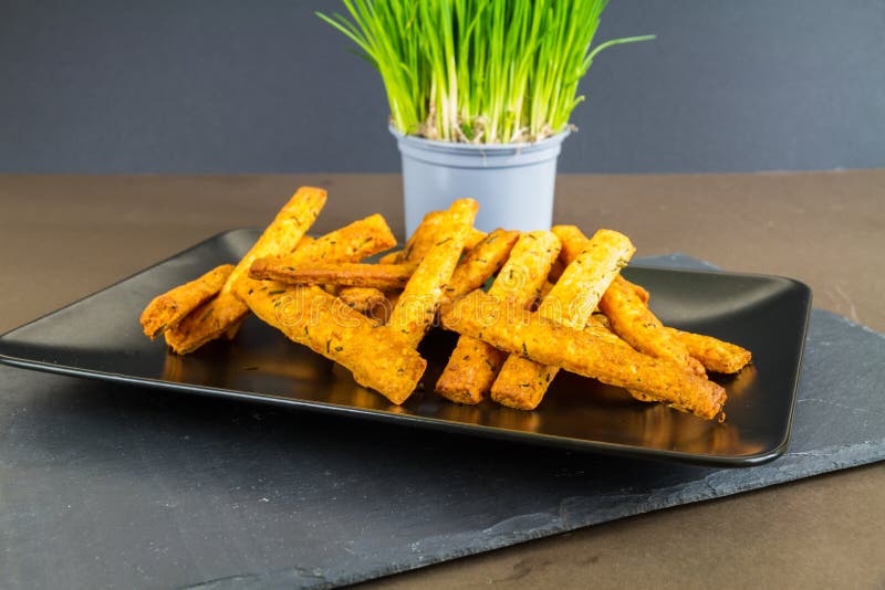 Plate of cheese straws Plate of stacked cheese straws with chives, landscap...