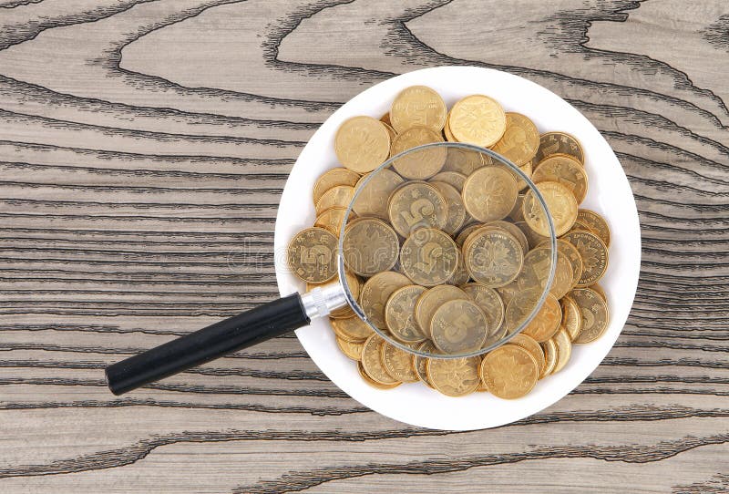A Plate of Coins and a Magnifying Glass Stock Image Image of indoor