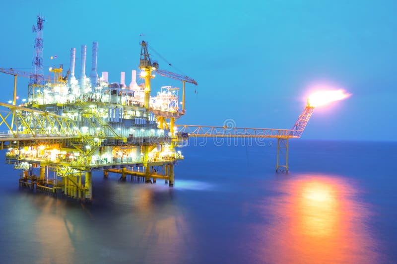 Oil and rig platform in sunset or sunrise time. Oil and rig platform in sunset or sunrise time