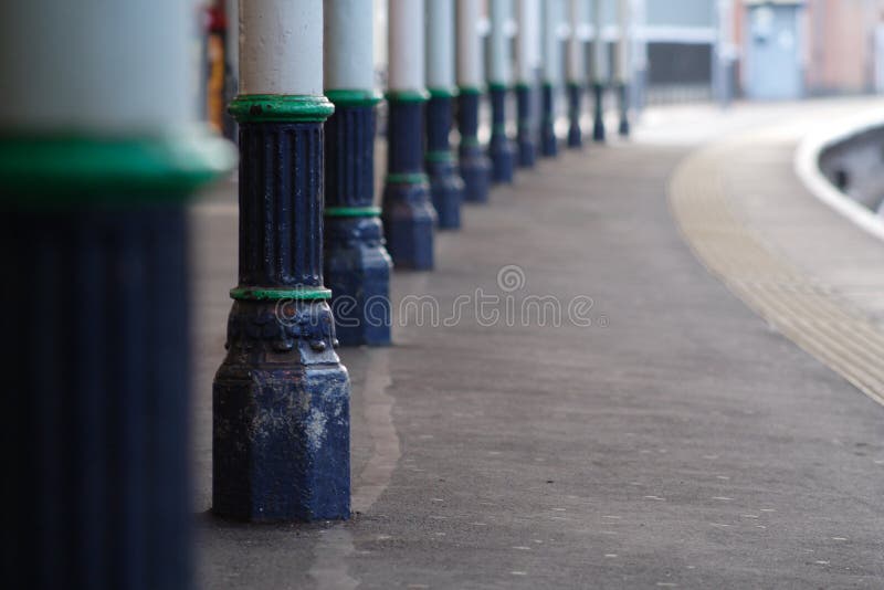 Cast iron columns on train station platform, shallow DOF, focus on second column. Cast iron columns on train station platform, shallow DOF, focus on second column.