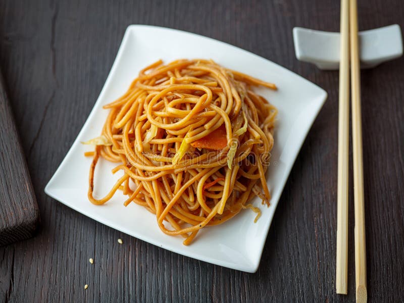 Plate of fried noodles with vegetables