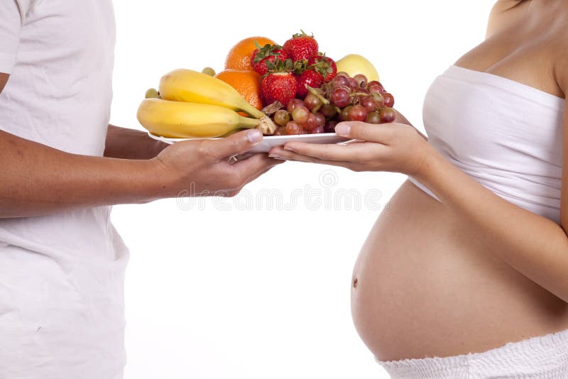 Plate of fruit pregnant couple